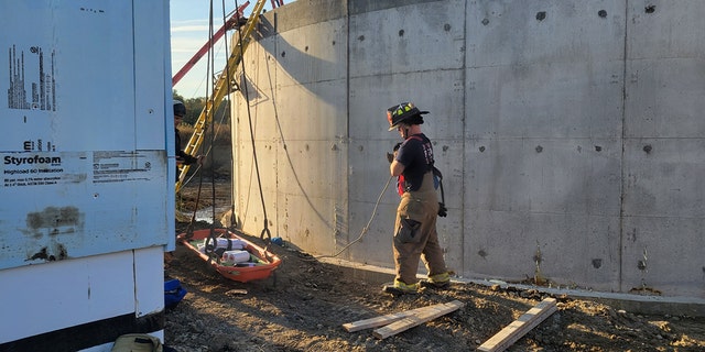 Man injured after falling 25 feet into a concrete tank rescued by an Iowa crane operator